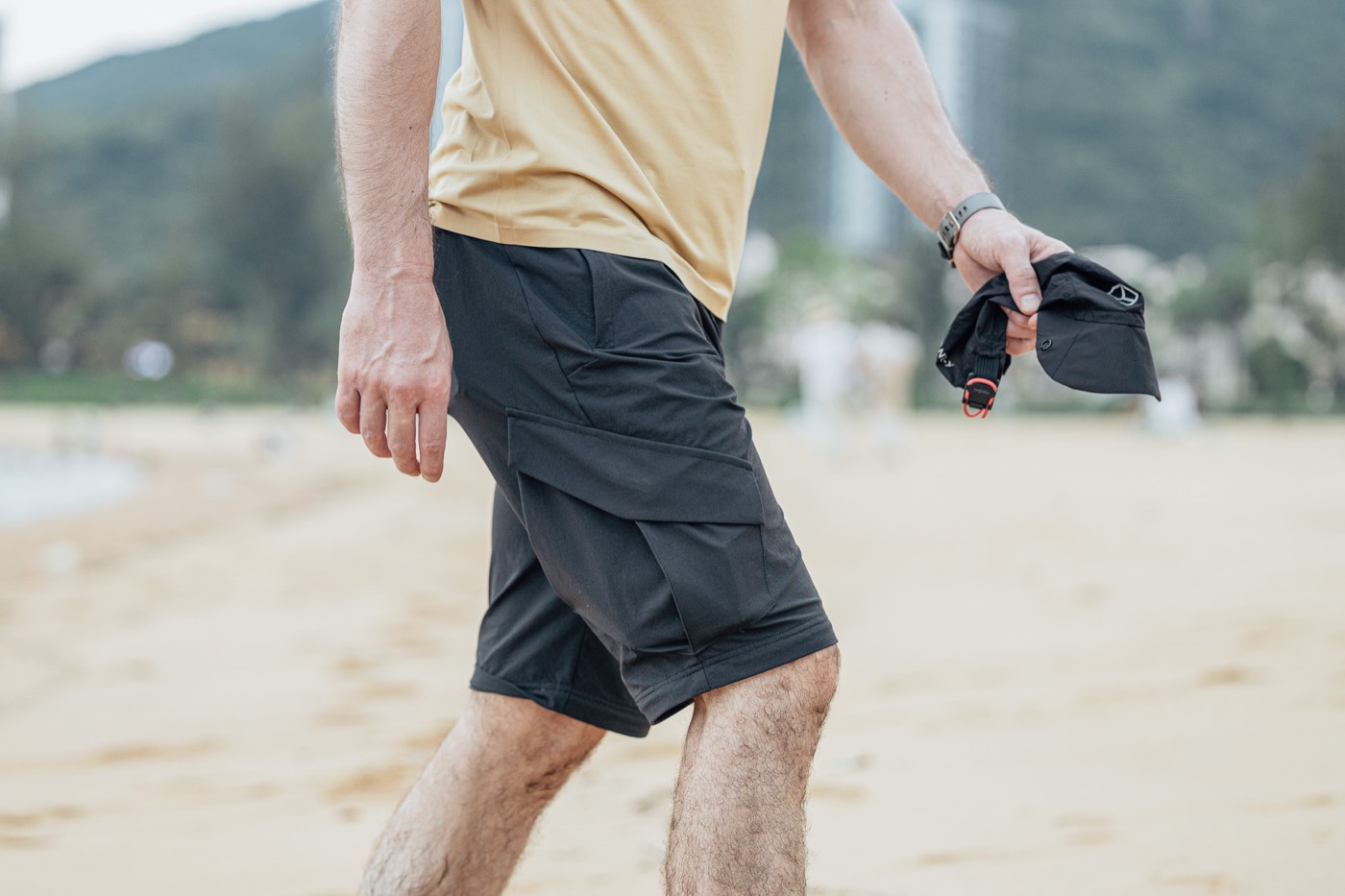 Walking on the beach in All Rounder Adventure shorts, the removed lower legs in hand.