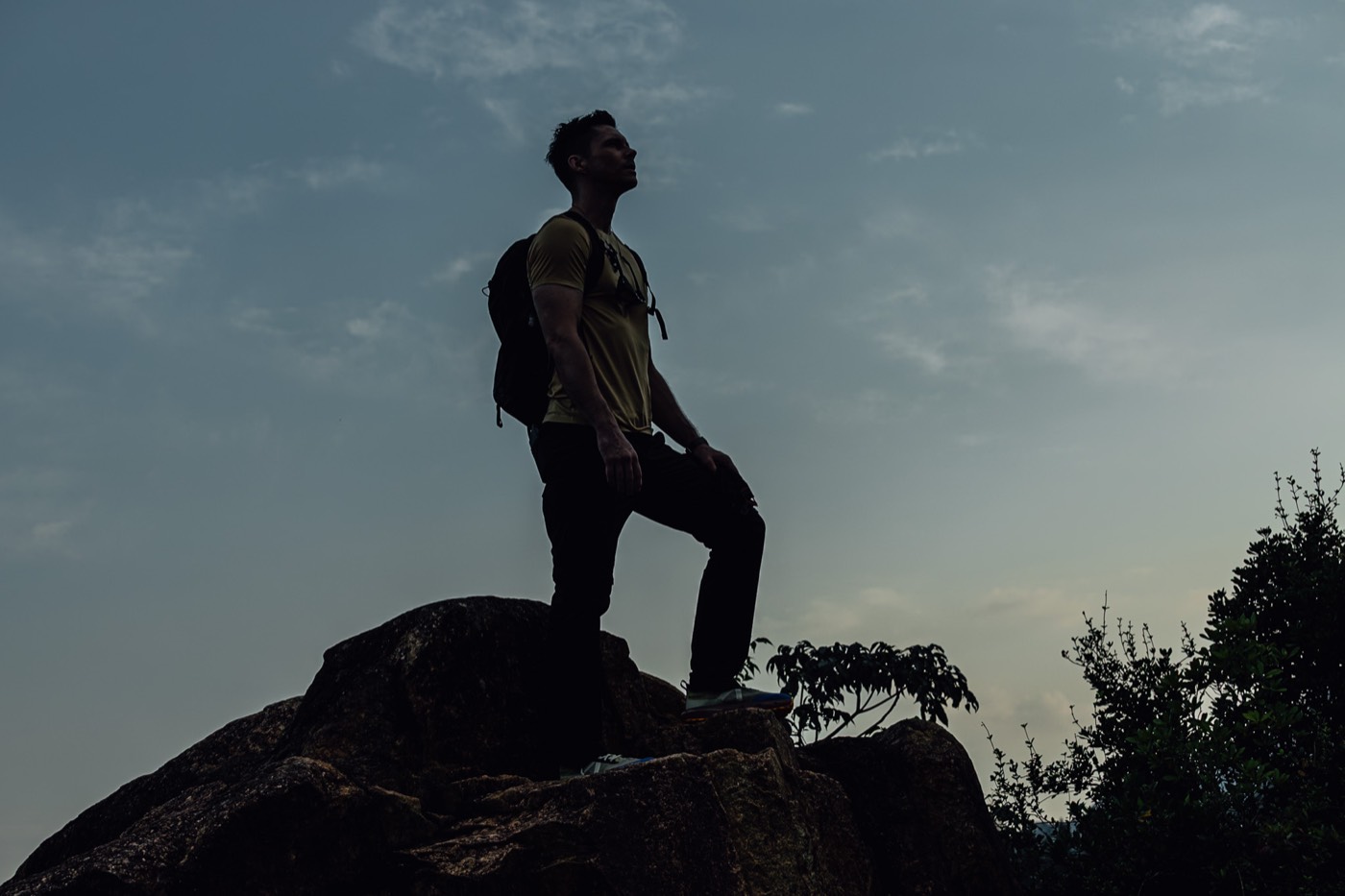 Silhouette on a boulder at dusk in All Rounder Adventure.