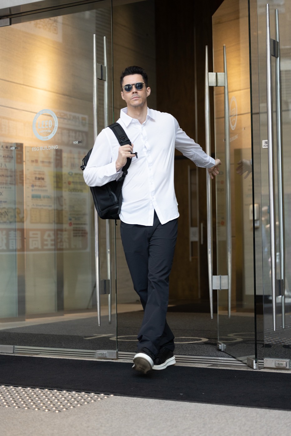 Stepping out of an office lobby in All Rounder Urban.