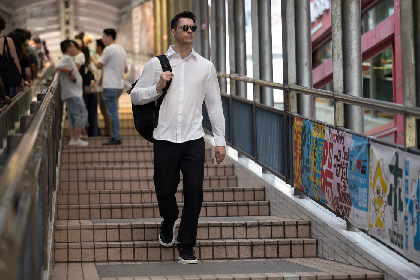 Walking down covered footbridge stairs in Hong Kong in All Rounder Urban.