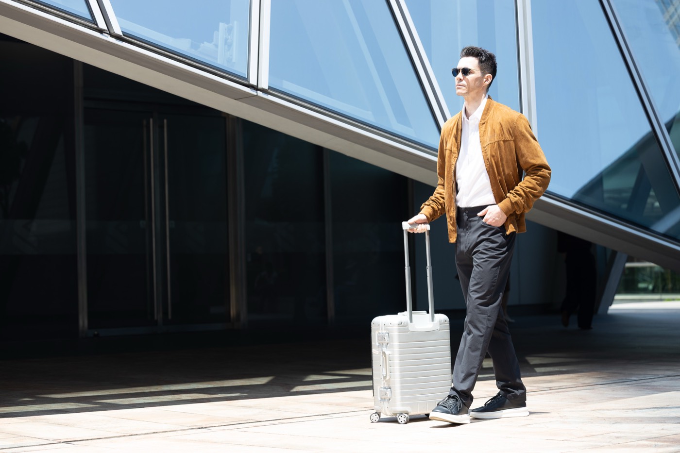 Walking a carry-on past a glass building in All Rounder Urban.